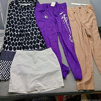All four size-small bottoms laid flat: print pants, white skirt, purple sweatpants, tan pants (tag visible)