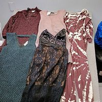 Overview of five garments laid side by side