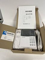 Box opened showing monitor unit, handset, manuals