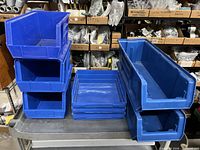 Group of blue AkroBins stacked on cart