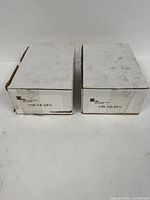 Two sealed white EMI HB-14-24V cartons