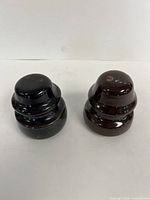 Front view of both insulators showing overall form and glazing