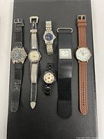 Six watches laid out side by side