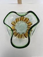 Top view showing freeform shape, green rim and amber interior petals