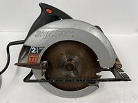 Left side view showing blade, guard, SkilSaw branding