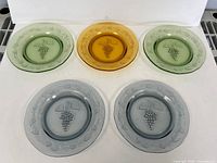 Five mixed-colour frosted grape plates overview