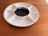 assembled lazy susan showing ceramic dishes on base