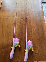 Both fishing rod and reel combos side by side on table