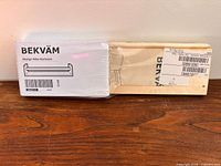 Sealed IKEA BEKVÄM spice rack full view on wooden surface