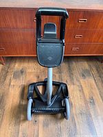 Front view of Polaris caddy cart showing handle, mount plate and wheeled base