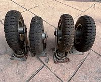 Four pneumatic swivel casters lined up showing overall condition