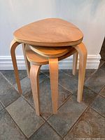 Three birch stools stacked vertically