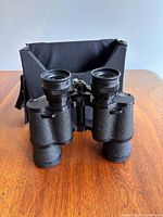 Binoculars front view with case behind