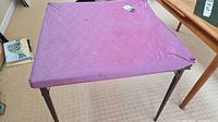 table with purple quilted cover in full view