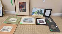Group shot showing all framed and matted artworks laid out on floor