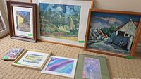 Group shot of seven framed paintings showing subjects and frames