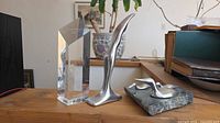 Group shot showing acrylic award, single bird sculpture, and slate base with twin birds