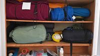 Shelved sleeping bags, pads, stuff sacks and small accessories