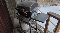 Front view of closed Master Chef grill showing wheels, side shelf and propane tank