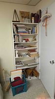 Overall view of shelving unit, easel, and storage tote with art supplies
