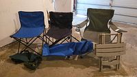 Group view showing three folding chairs, two carry bags, stacked plastic stools
