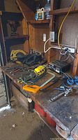 Workbench with circular saw, belt sander, cordless drill, battery charger, hand tools