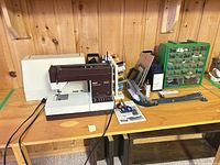 Overall lot showing machine, cover, accessories on table