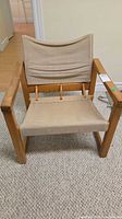 Front view of wood and canvas armchair
