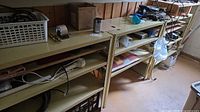 Full view of two of the beige metal shelving units with contents for scale