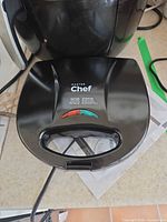 Master Chef black sandwich grill in front of coffee maker