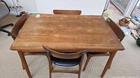 Top view of teak dining table with four matching chairs