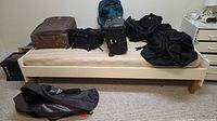 Multiple luggage pieces laid on a bed showing overall lot contents
