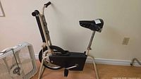 Exercise bike and box fan side by side