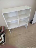 Front view of white 4-cubby bookshelf