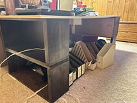 Side view showing white top and dark brown base with shelving and items underneath