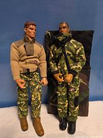 Both Lanard action figures standing with sleeping bag behind
