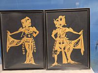 Both framed straw pictures side by side