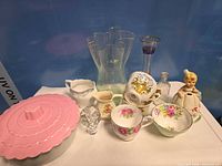 Group view of all items including casserole, crystal, porcelain pieces, glass vases