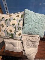 Group shot of two decorative pillows on two beige pillows/shams