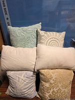 Front view of all six pillows showing patterns and colors