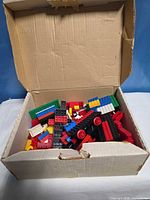 Cardboard box full of assorted Lego bricks
