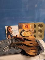 Group shot of cookbooks, baking pans, wooden spoons
