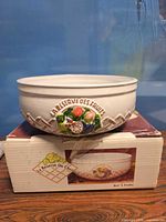 Overall view of ceramic bowl resting on its original box