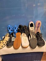 All six pairs of shoes lined up showing uppers and soles