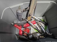 Overview of assorted pneumatic tools in tote