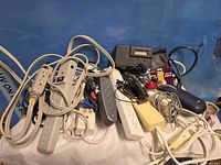 Overall lot showing surge protectors, cords, mouse and small devices