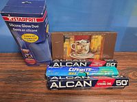 All items grouped: boxed gloves, boxed espresso set, two foil boxes, wax paper box