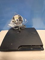 PS3 Slim console with power cord and MW3 disc