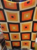 Full view of blanket showing overall square pattern and colors