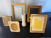 Group shot of five picture frames and milk glass vase